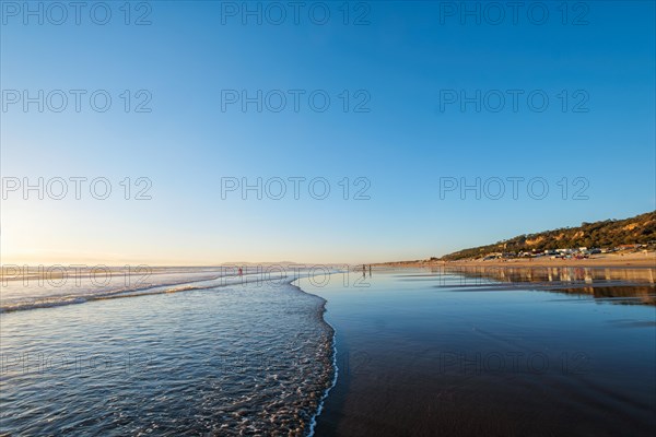 Atlantic ocean sunset with surging waves at Fonte da Telha beach