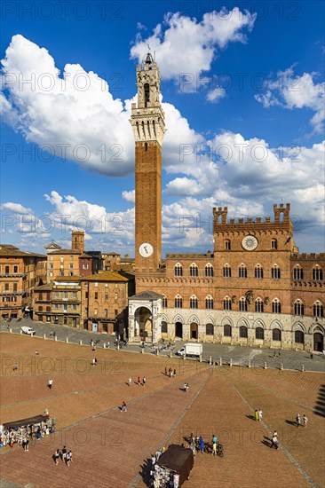 Spring clouds over the Piazza del Campo with the bell tower Torre del Mangia and the town hall Palazzo Pubblico