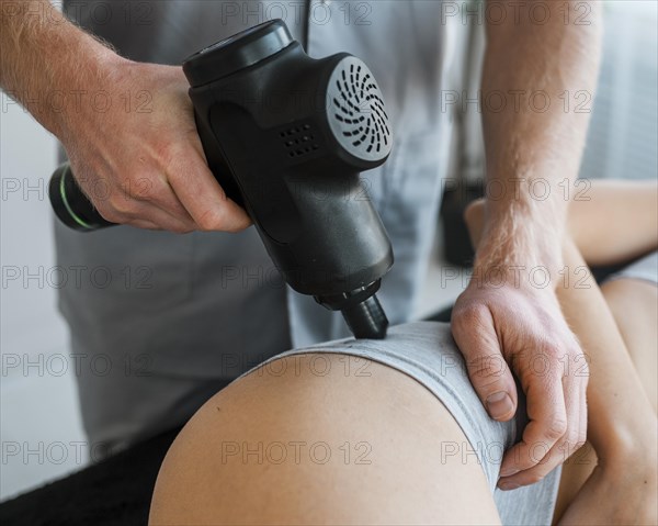 Male physiotherapist with woman equipment during physical therapy session