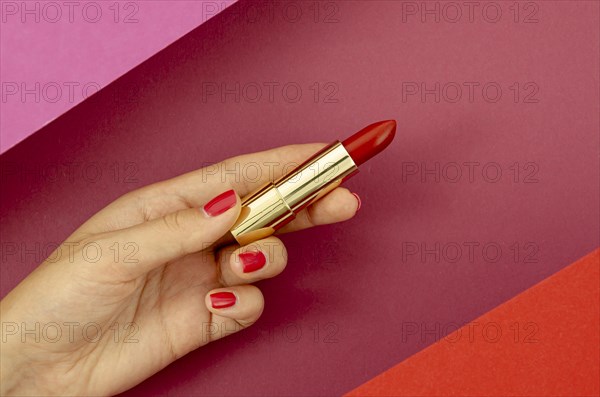 Top view woman holding red lipstick