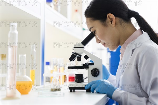 Side view female scientist working lab