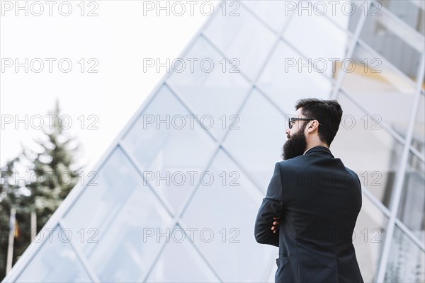 Close up businessman standing front corporate building