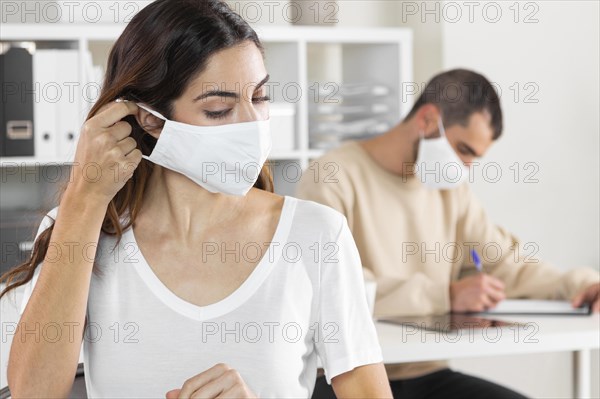 Close up woman taking off mask