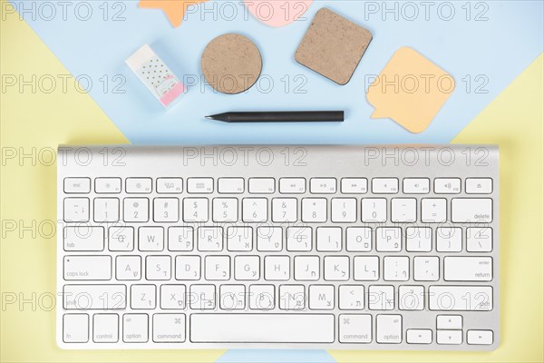 Shapes eraser pencil near white keyboard dual backdrop