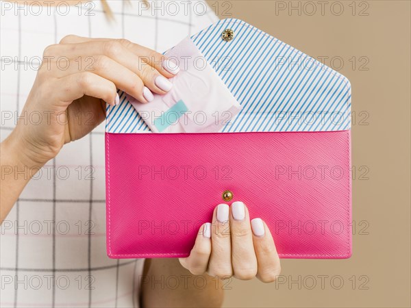 Woman holding pad pink wallet