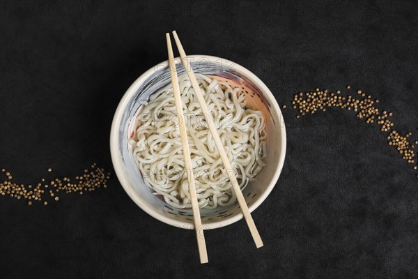 Homemade udon noodles japanese food with coriander seeds design black background