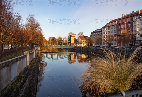 Iron bridge over the river Maltsch with the city wall of the historic old town of Ceske Budejovice