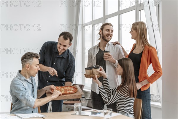 Businesspeople lunch break eating pizza