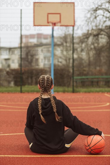 Teenager posing basketball field