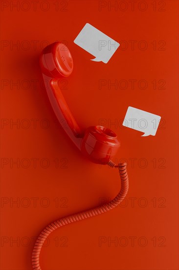 Top view telephone receiver with cord chat bubbles