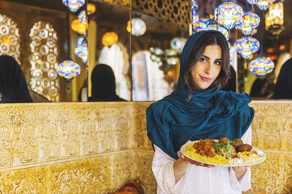Woman holding dish arab food