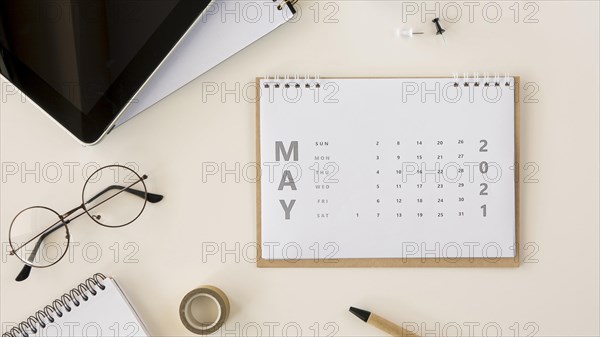 Flat lay desk calendar reading glasses