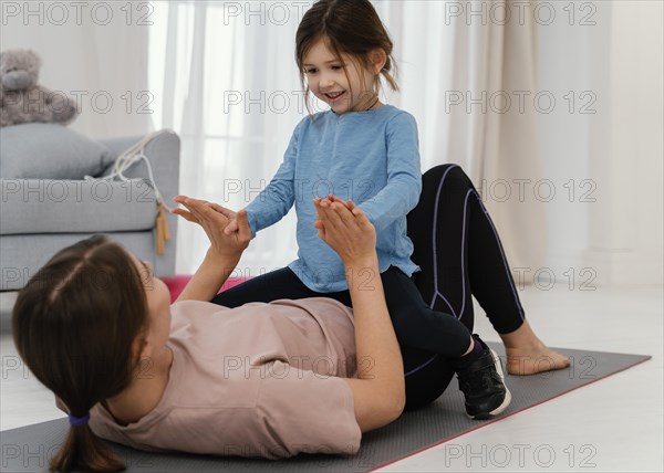 Mother training with smiley child
