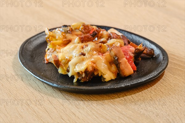 Mushroom pasta with tomato and chanterelles on a plate