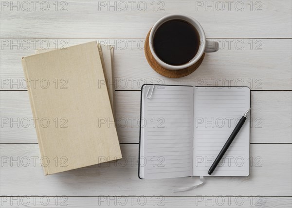 Top view arrangement with books cup