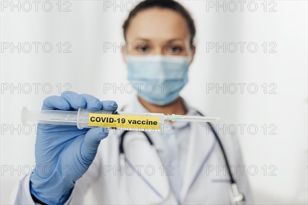 Close up doctor holding covid19 vaccine