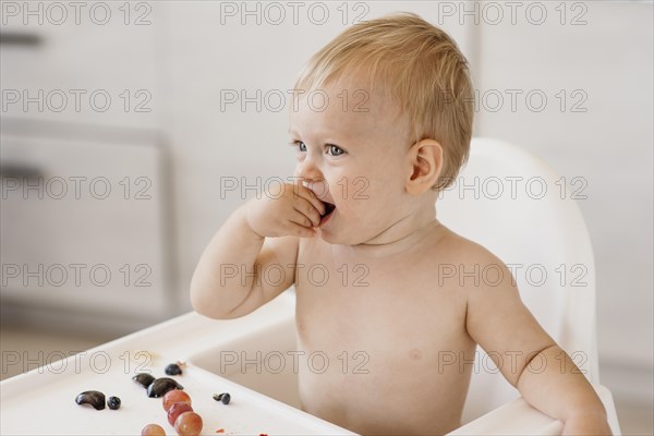 Side view cute baby eating alone