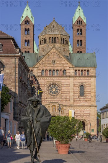 Bronze sculpture Jacob's Pilgrim by Martin Mayer and behind it The Imperial Cathedral of Speyer also called Speyer Cathedral or Cathedral Church of St Mary and St Stephen