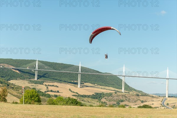 Paraglider in front of the Millau Bridge. Grands Causses
