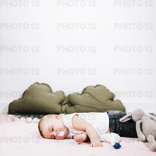 Cute baby sleeping peacefully nursery floor