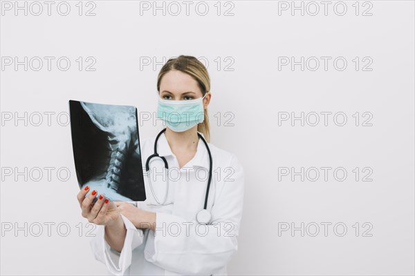 Doctor mask examining x ray picture