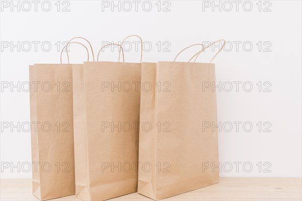 Close up paper shopping bags wooden desk