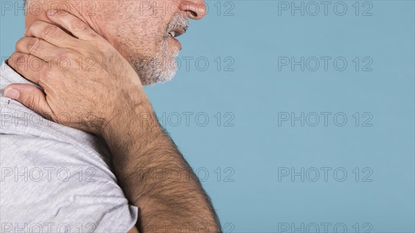 Side view senior man suffering from neck pain