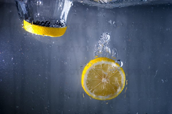 Two slices lemon falling water