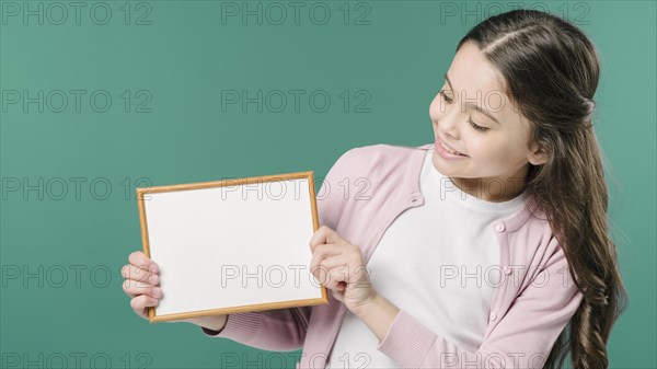 Girl holding empty picture frame