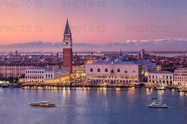 Waterfront with Campanile and Doge's Palace in front of the Alpine chain at dusk