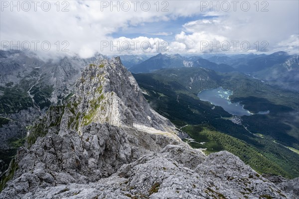 View from the summit of the Waxenstein over rocky and narrow ridge of the Waxenstein ridge to Eibsee lake