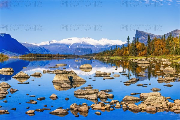 Mirrored lake in a beautiful mountainous landscape at rapa valley in Sarek national park in Sweden