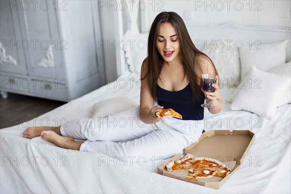 High angle woman home having pizza