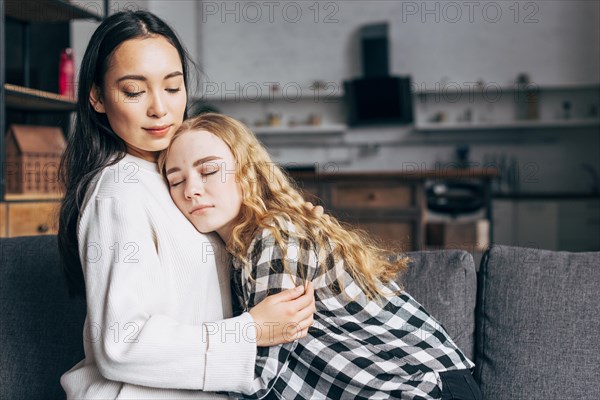Woman comforting female friend