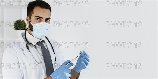 Doctor preparing vaccine with copy space