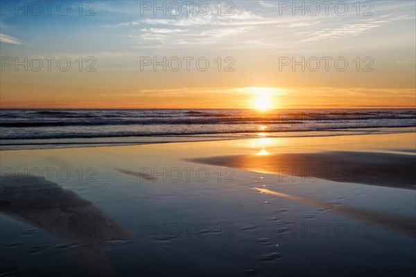 Atlantic ocean sunset with surging waves at Fonte da Telha beach