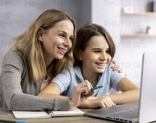 Mother helping daughter study