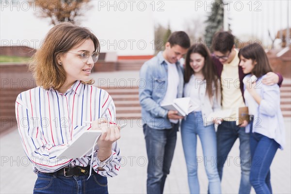 Woman glasses standing holding notebook hands