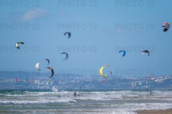 Kiteboarding kitesurfing kiteboarder kitesurfer kites on the Atlantic ocean beach at Fonte da Telha beach