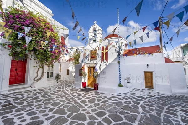 Cycladic Greek Orthodox Church decorated with flags