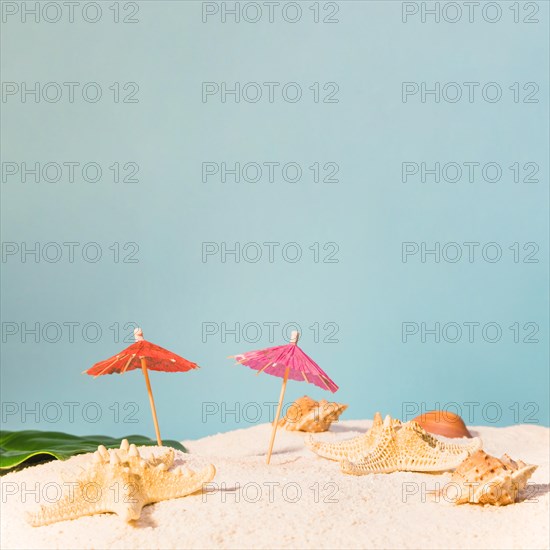 Beach with red sun umbrellas starfishes