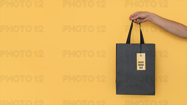 Black friday shopping bag yellow copy space background