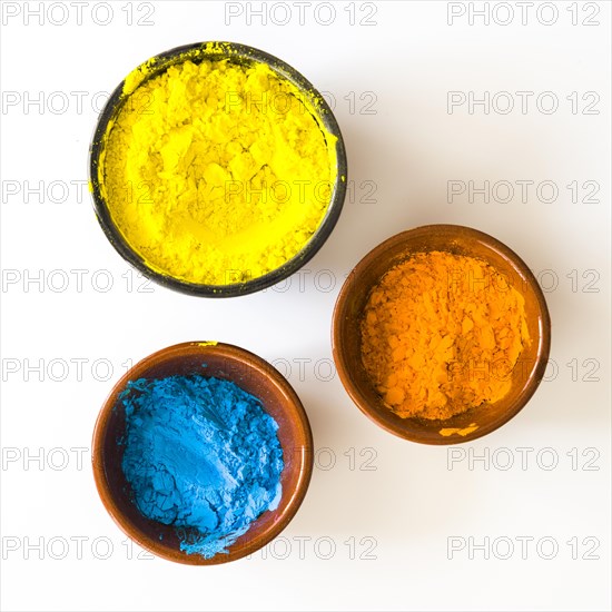 Bowls yellow orange blue color powder isolated white background