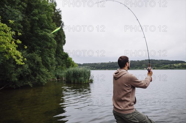 Side view man fishing lake