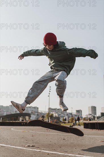 Front view teenager with skateboard outside