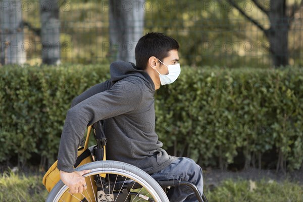 Medium shot disabled man wearing mask