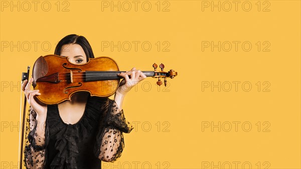 Girl hiding violin