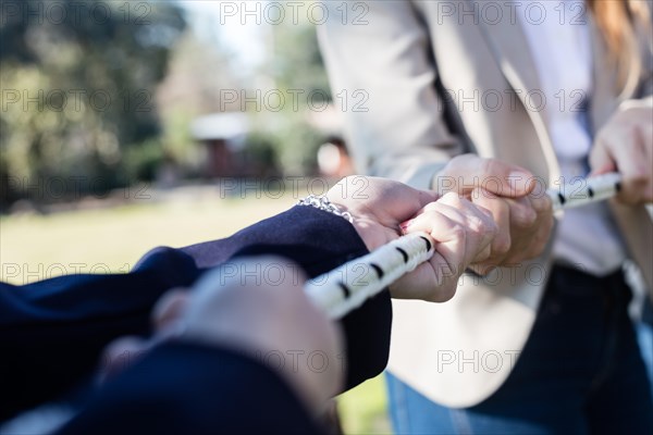 Close up hands pulling rope