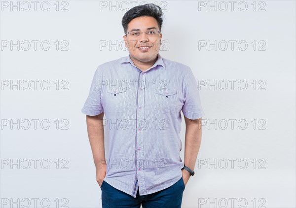 Portrait of smiling latin man with hands in pocket isolated. Young casual latin man with hands in pocket. Smiling young nicaraguan man isolated