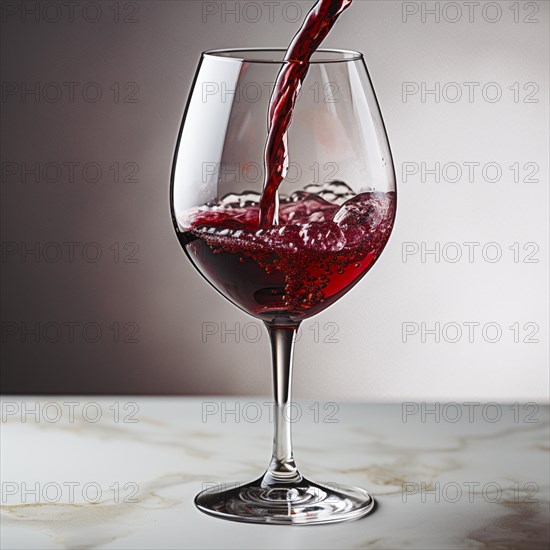 Wine is poured into elegant wine glasses